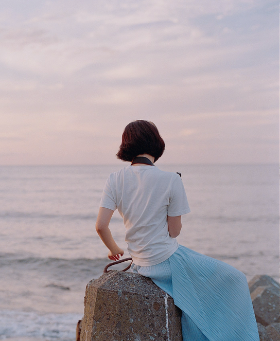 Woman gazing at the sea at dusk