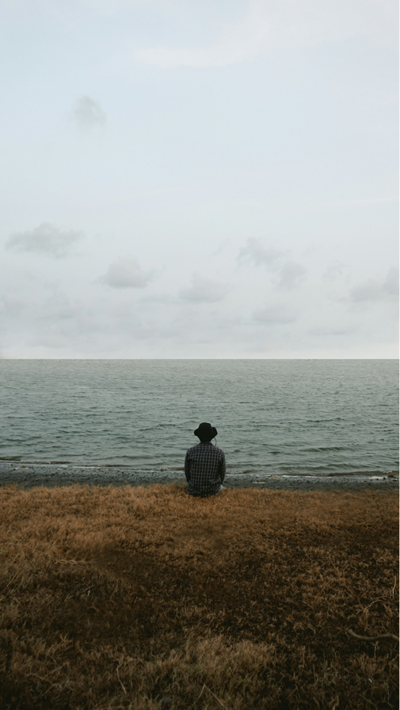 a man looking at the ocean